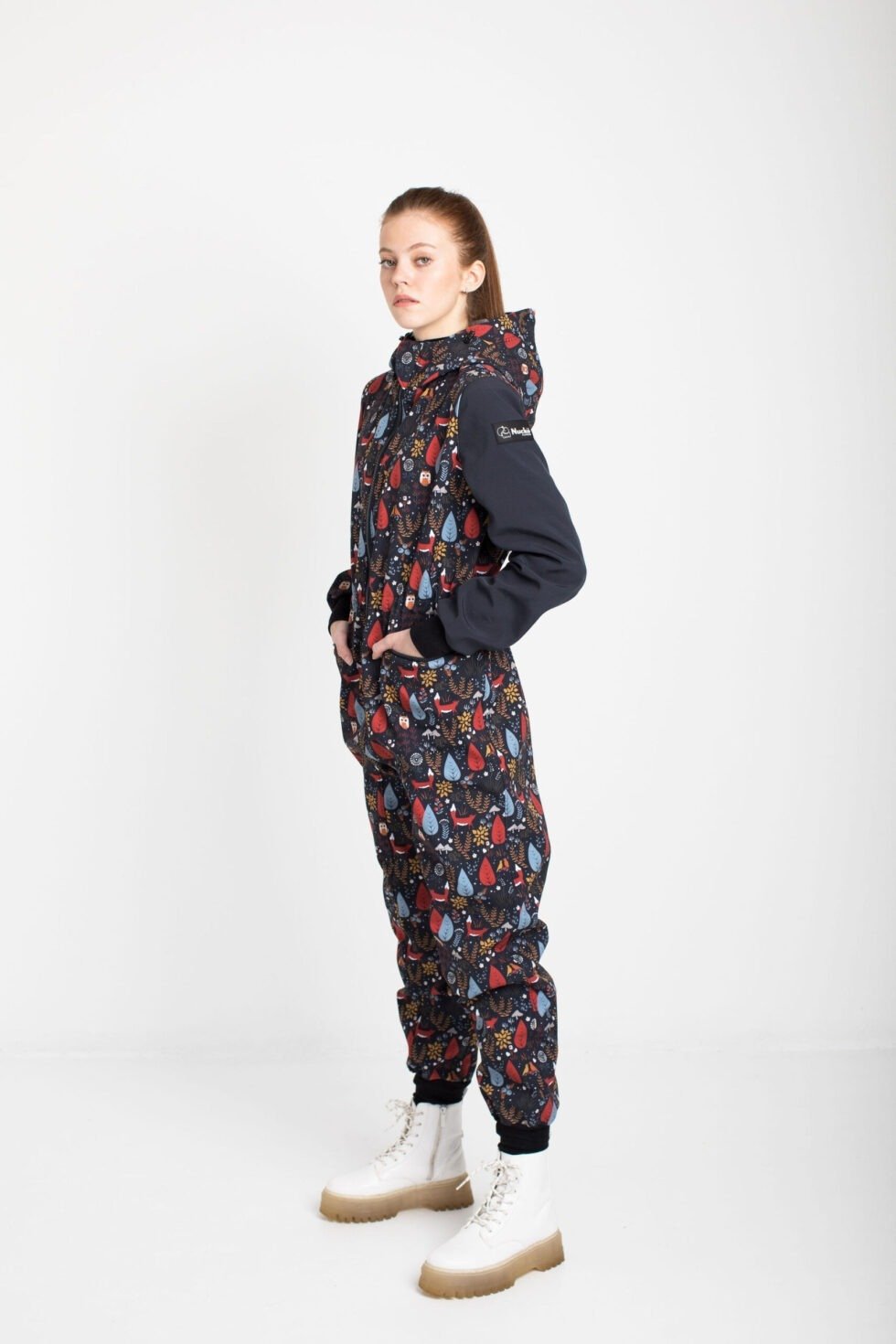 2. Side view of women's EBEKAI softshell overall by Nuckö, highlighting waterproof fabric and elastic waist