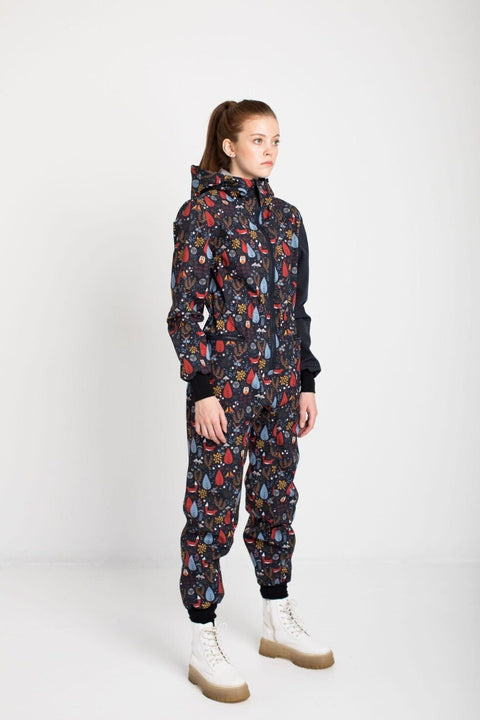1. Women's EBEKAI softshell overall by Nuckö in studio, showcasing digital print pattern and adjustable hood