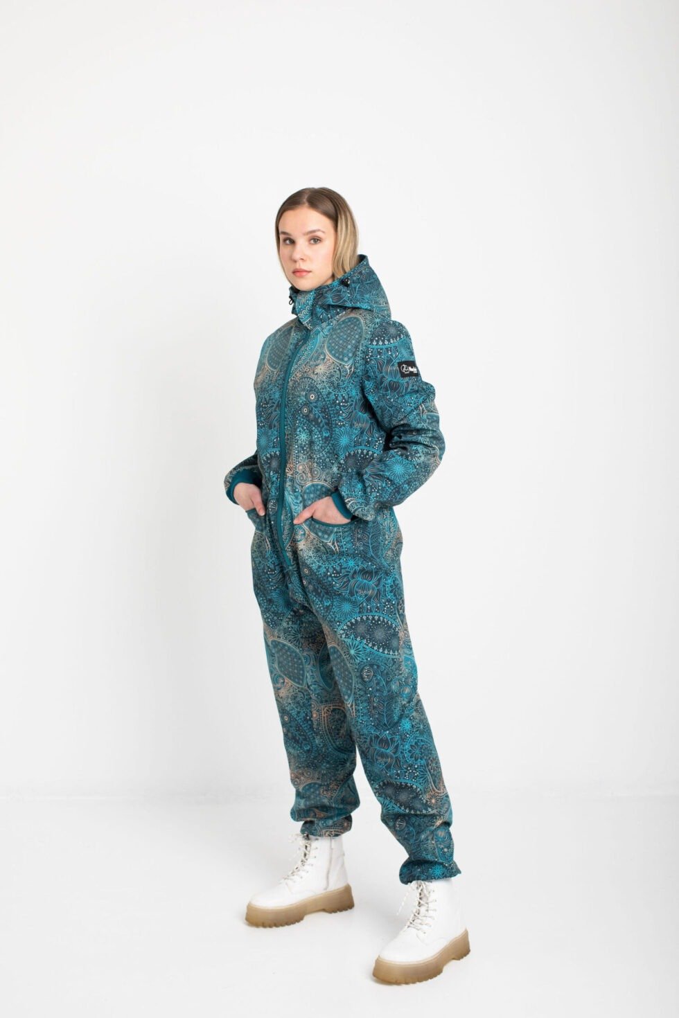 1. Women's KARINA softshell overall by Nuckö in blue digital print, shown in studio setting