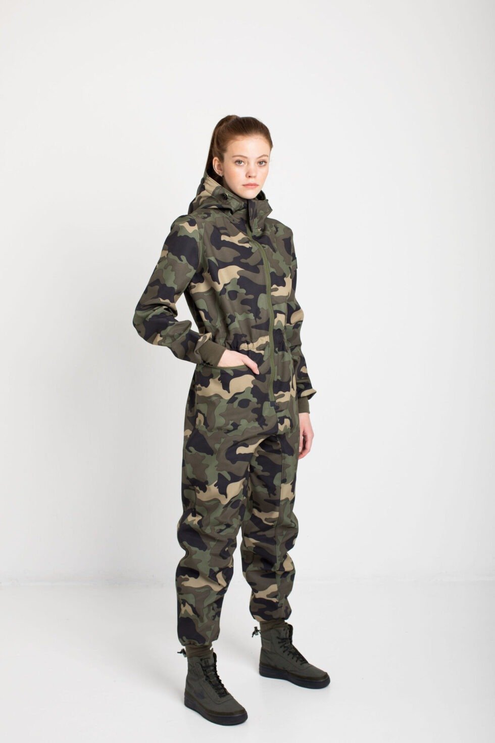 3. Side view of women's SUSANNA softshell overall by Nuckö in camo, studio shot