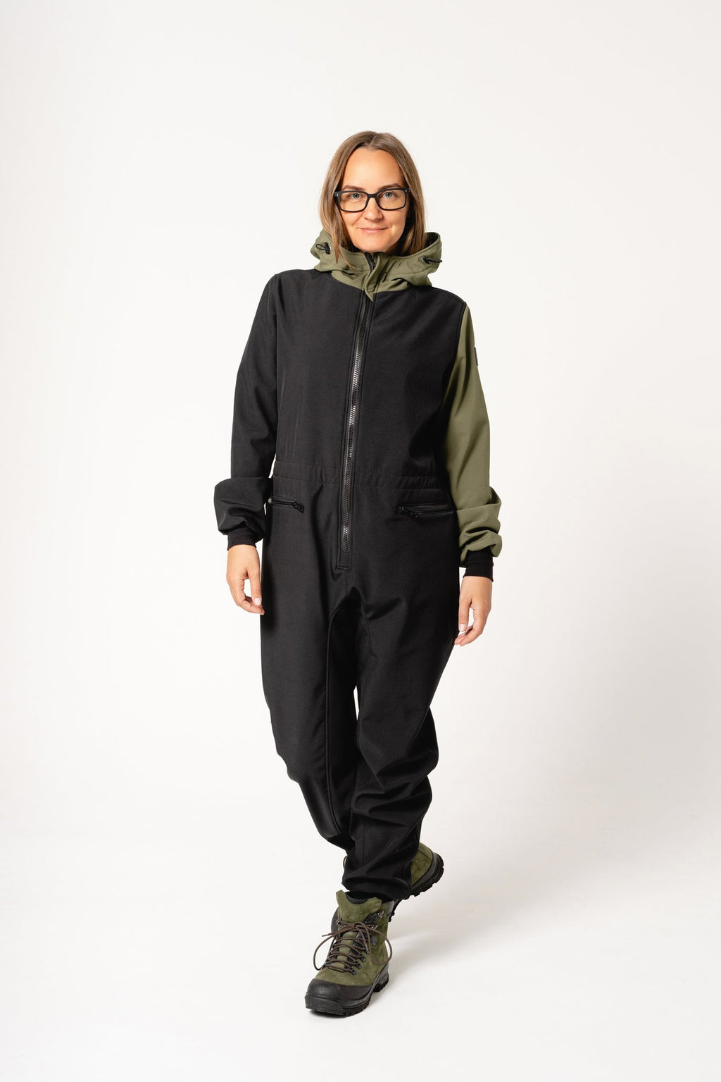 4. Women's CAROLA softshell overall by Nuckö in black and green, shown walking in studio