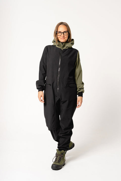 4. Women's CAROLA softshell overall by Nuckö in black and green, shown walking in studio