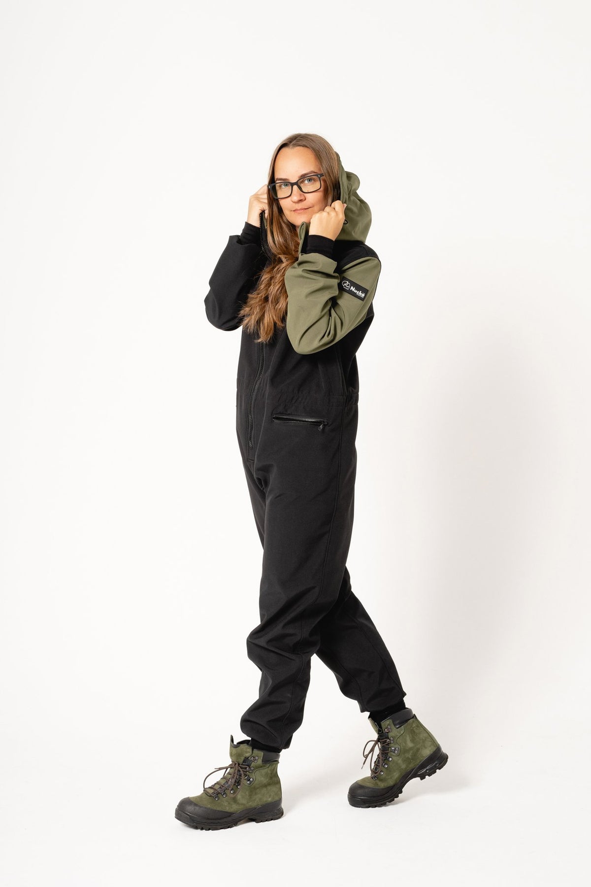 2. Women's CAROLA softshell overall by Nuckö in black and green, shown with adjustable hood in studio