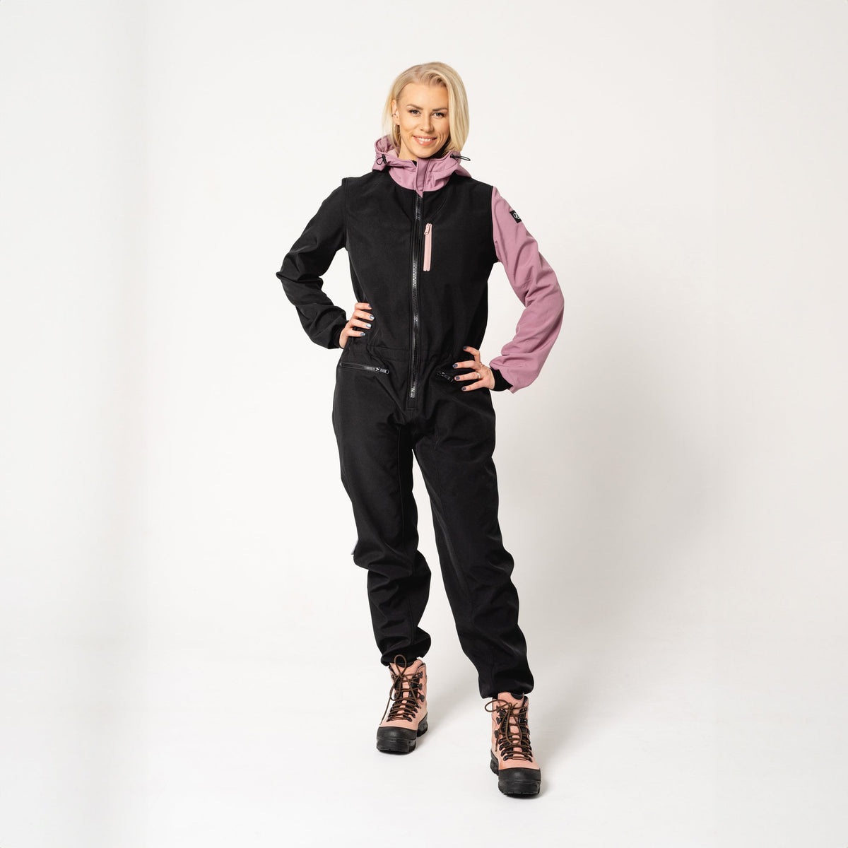 2. Women's Eeva softshell overall by Nuckö in black and pink, shown on a model in a studio