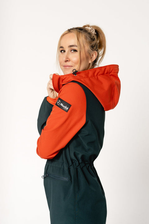 2. Women's Kristel softshell overall by Nuckö in dark green and orange, shown from the side with adjustable hood