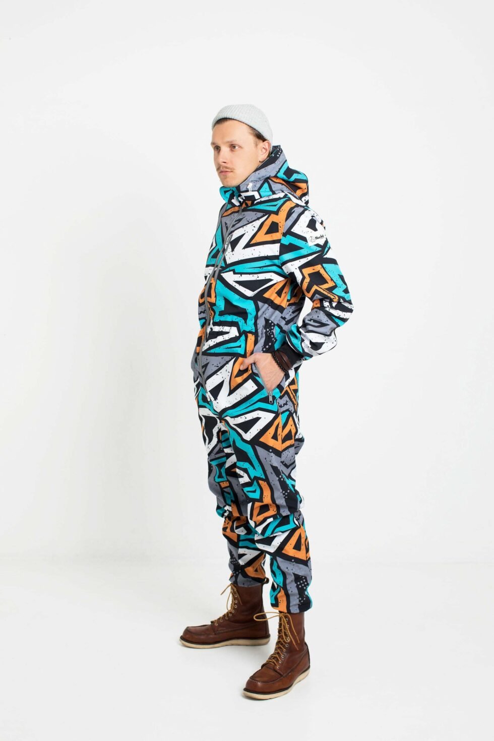 4. Man in Nuckö TANIEL softshell overall with geometric print, side angle, studio background