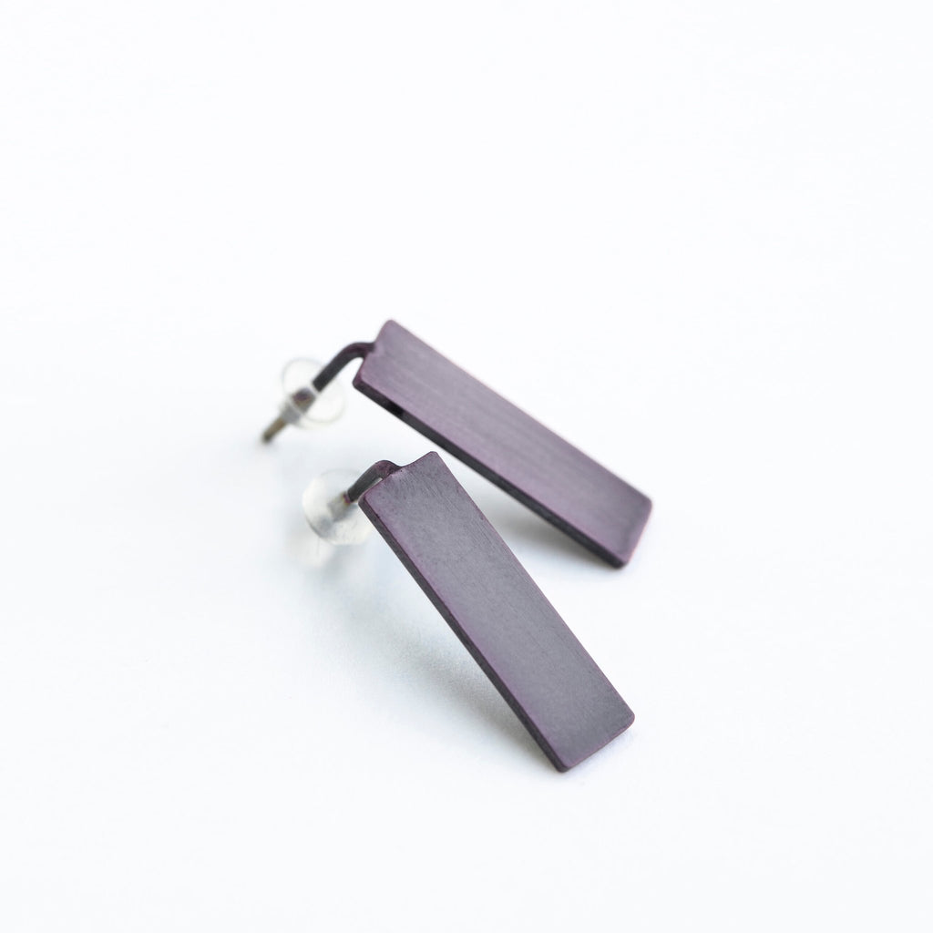 6. Studio shot of Lentsius Corner Purple earrings, highlighting brushed surface and silicone stoppers