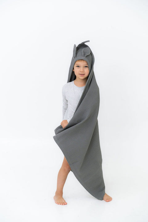 1. Child wearing gray waffle fabric towel with bunny ears hood standing on white background