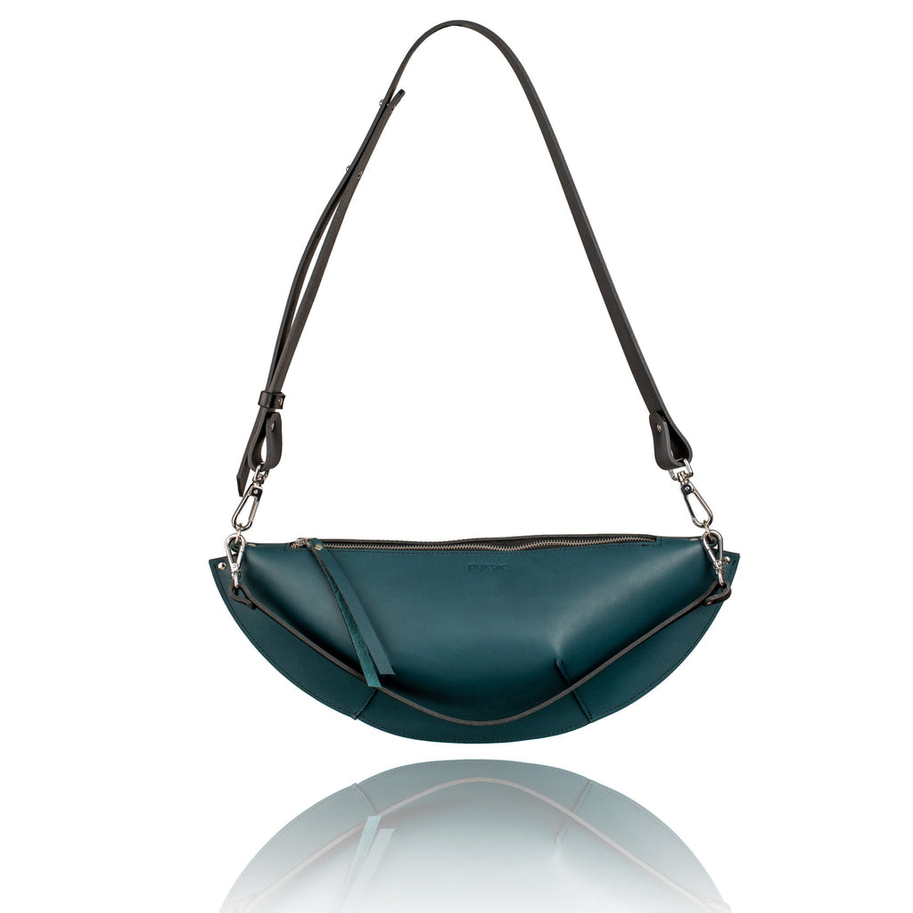 2. PYKOK Olivia ocean blue handbag with long adjustable strap, highlighting versatile styling in studio