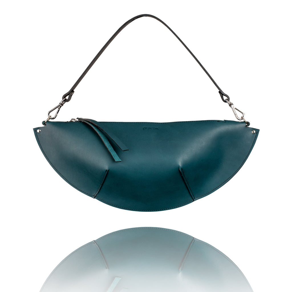 1. PYKOK Olivia ocean blue handbag with short handle, showcasing unique geometric shape in studio setting