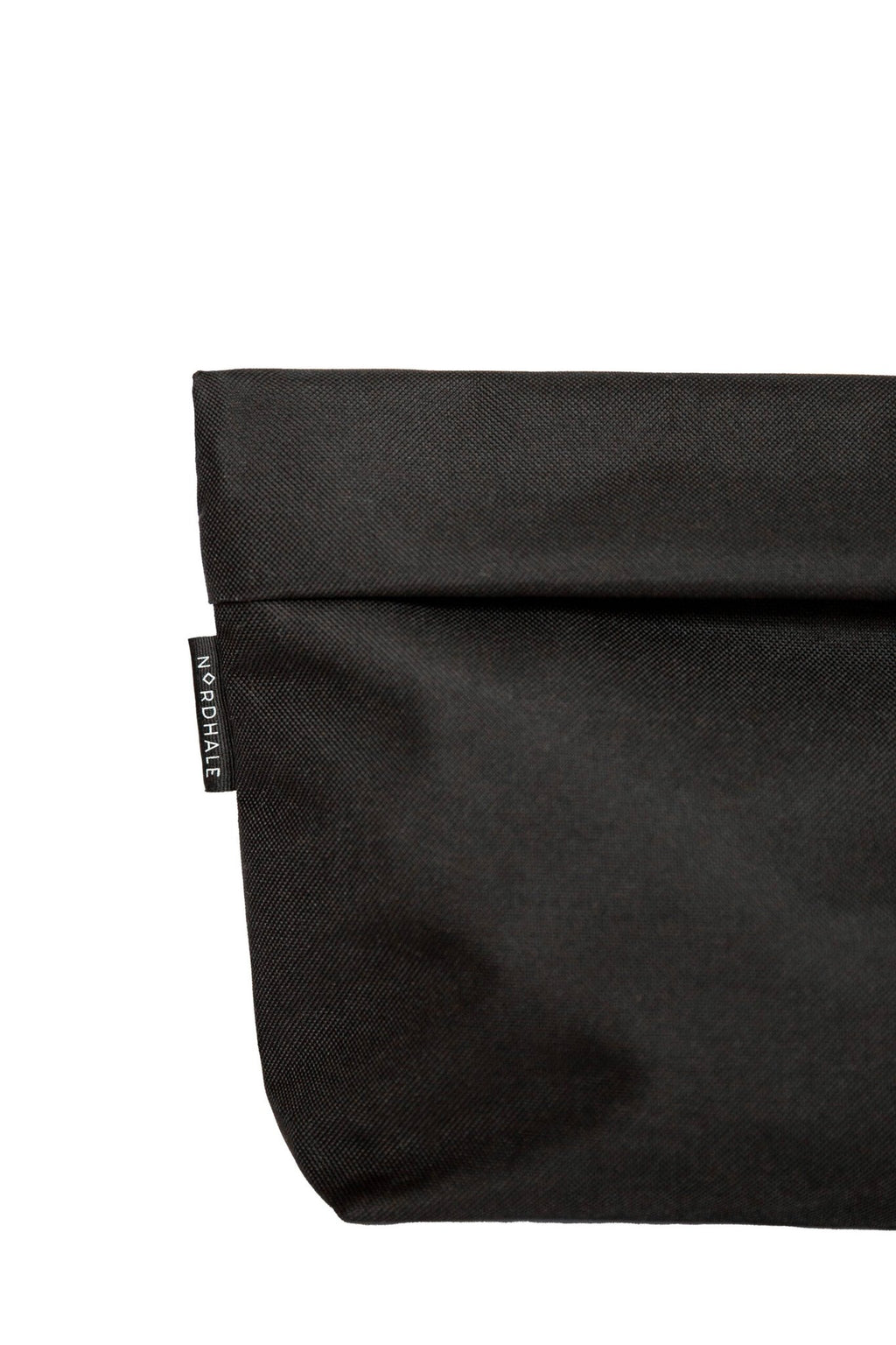 7. Close-up of Nordhale branding on black NES Toiletry Bag, showcasing fabric texture