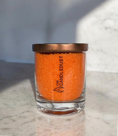 3. Studio shot of Candledust unscented orange powder candle in glass with copper lid, highlighting brand logo