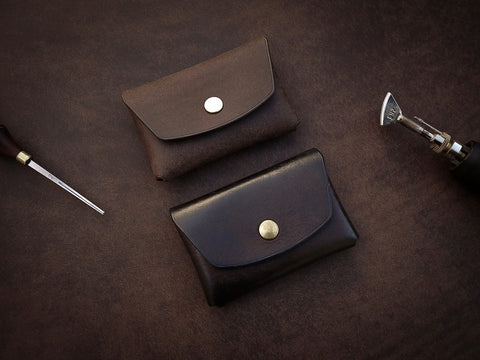 5. Pair of Mirgoods dark brown button leather wallets, showcasing polished edges and brass snaps