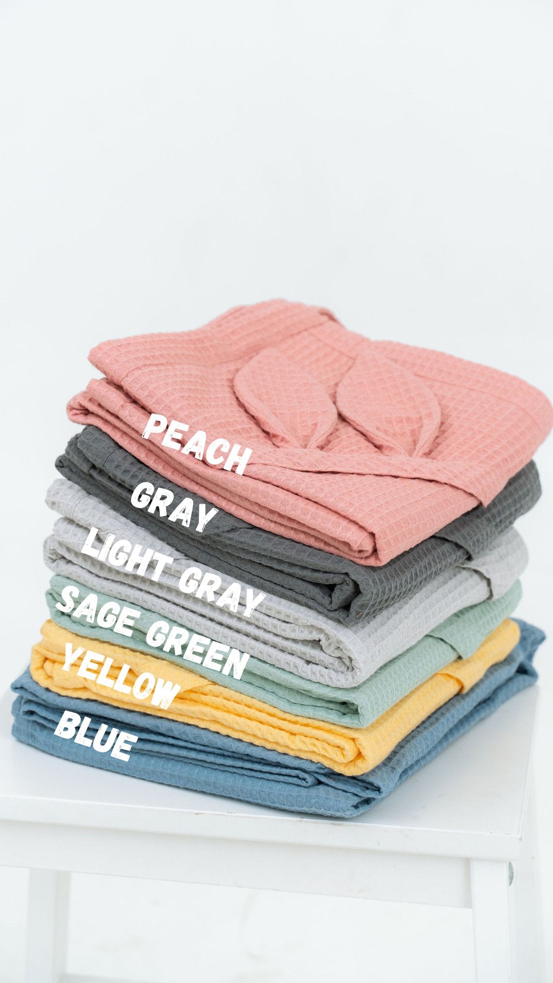 5. Size chart showing waffle fabric towels in peach, gray, light gray, sage green, yellow, and blue