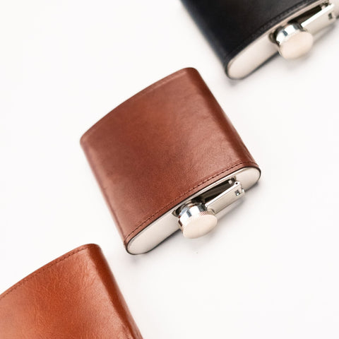 4. Close-up of Papillon Hip Flask No. 21 in brown leather, showing stainless steel cap