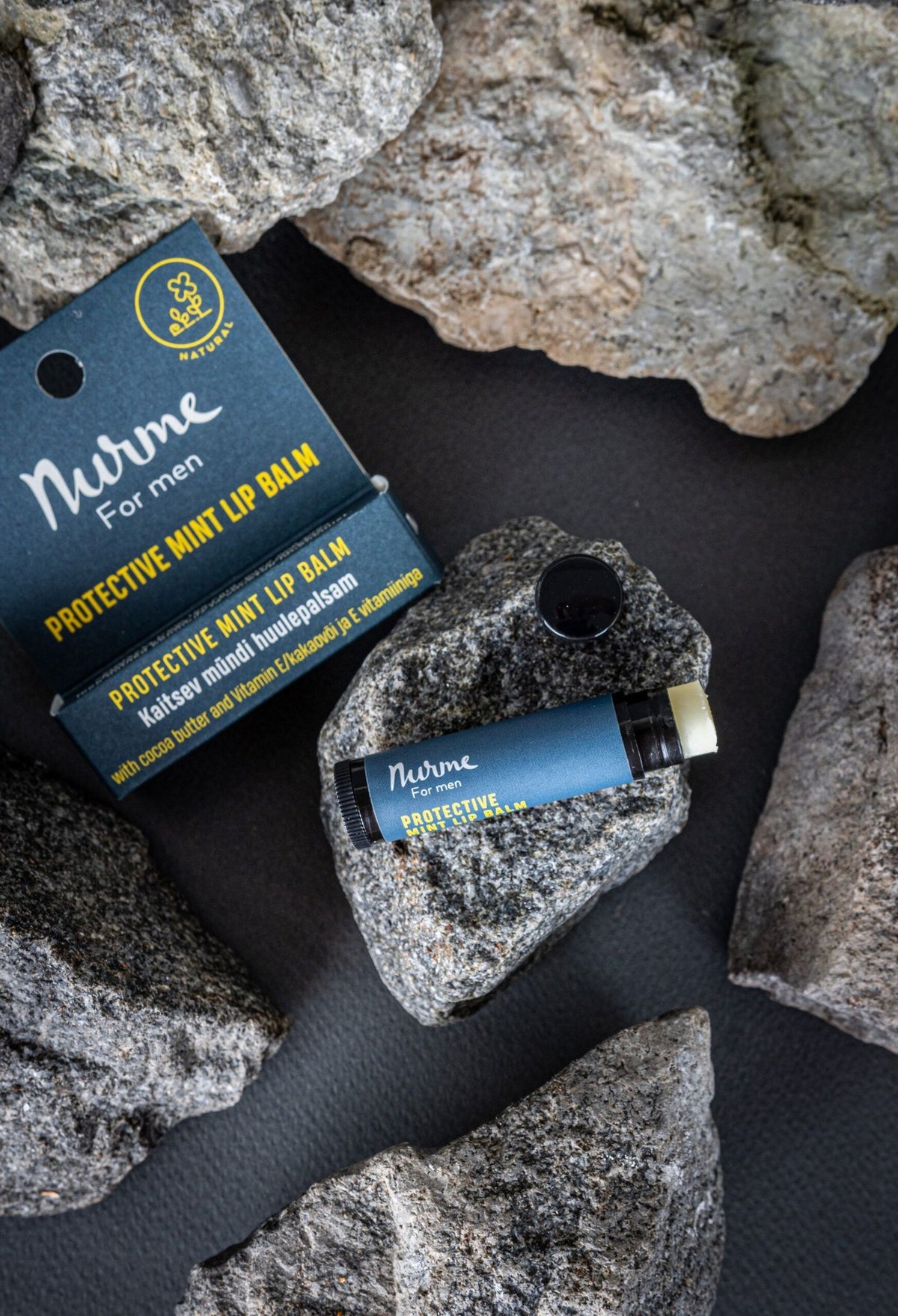 5. Nurme Protective Mint Lip Balm for men displayed on rocks, emphasizing natural ingredients
