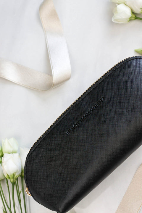 3. SEIK black pencil case with embossed 'IF NOT NOW, WHEN?' text, shown with flowers