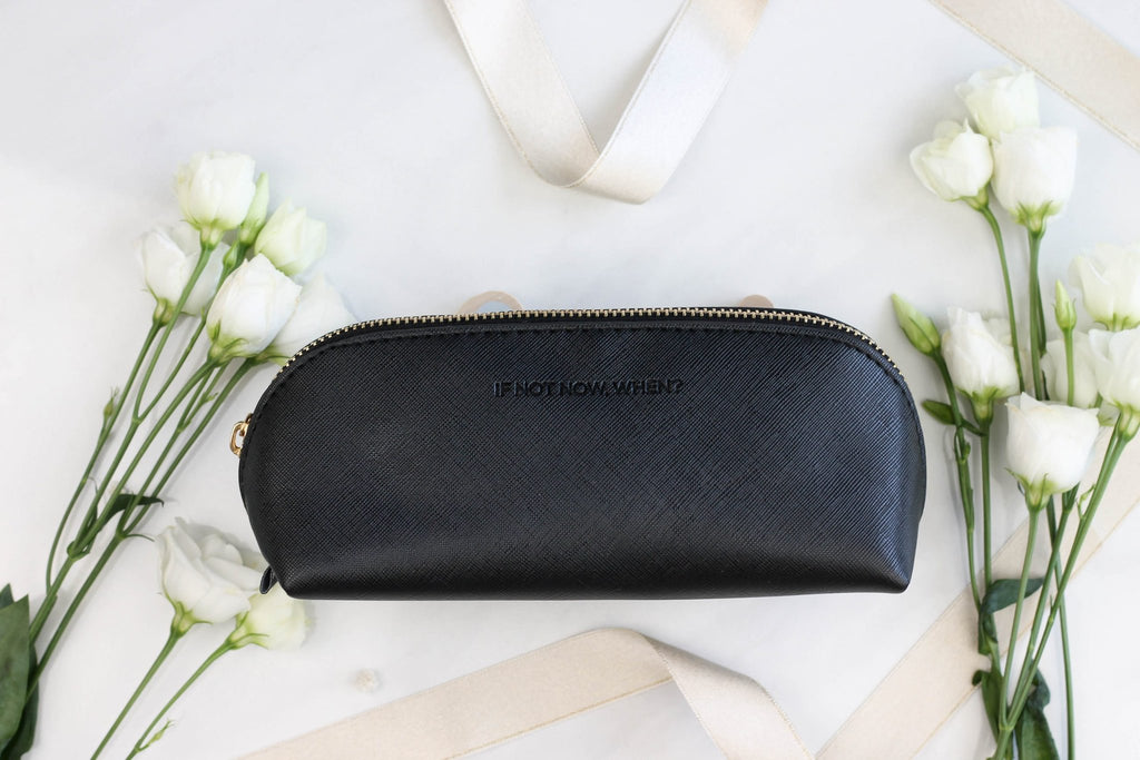 5. SEIK black pencil case with 'IF NOT NOW, WHEN?' text, displayed with white flowers