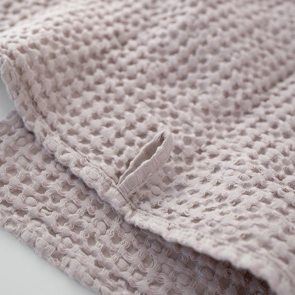 5. Close-up of powder-colored honeycomb waffle towel with hanging loop detail