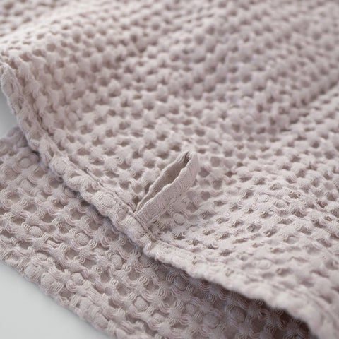 5. Close-up of powder-colored honeycomb waffle towel with hanging loop detail