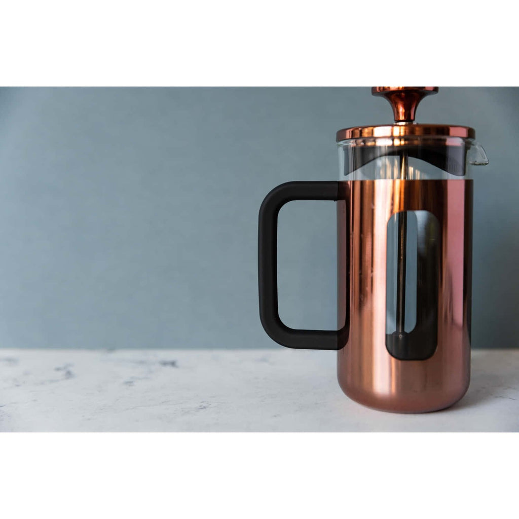 4. Lifestyle shot of La Cafetière Pisa coffee maker in copper on marble surface with blue background