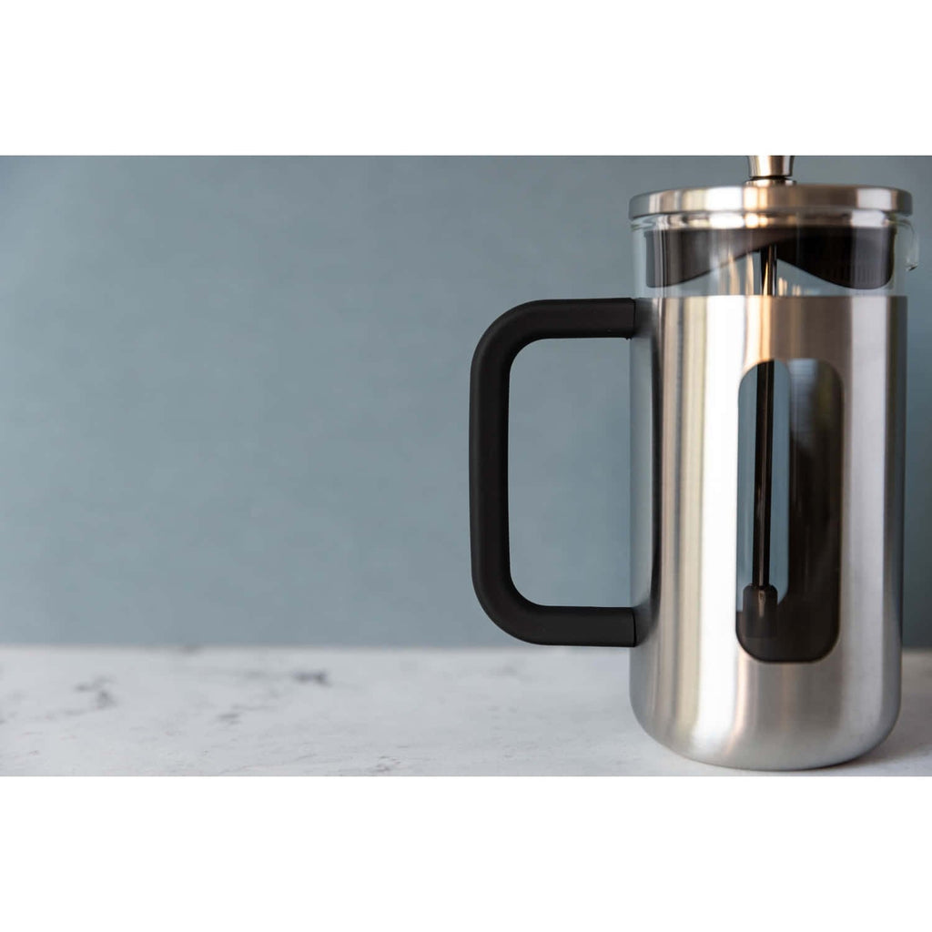 1. La Cafetière Pisa Coffee Maker in silver with black handle on marble surface against blue wall