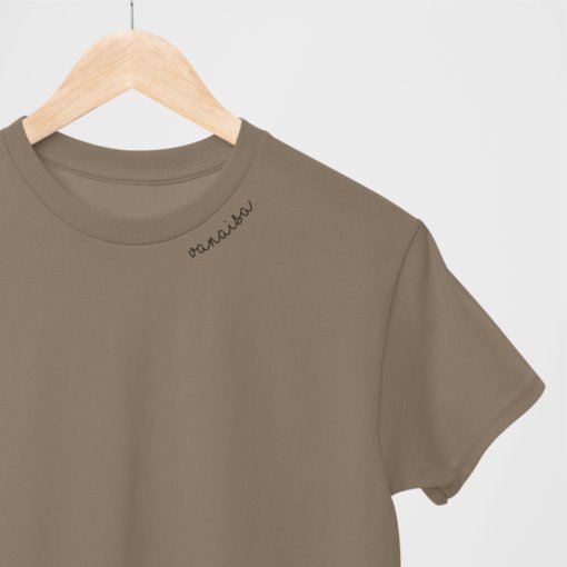 2. Studio shot of beige unisex organic cotton t-shirt with embroidered 'Vanaisa' collar on hanger