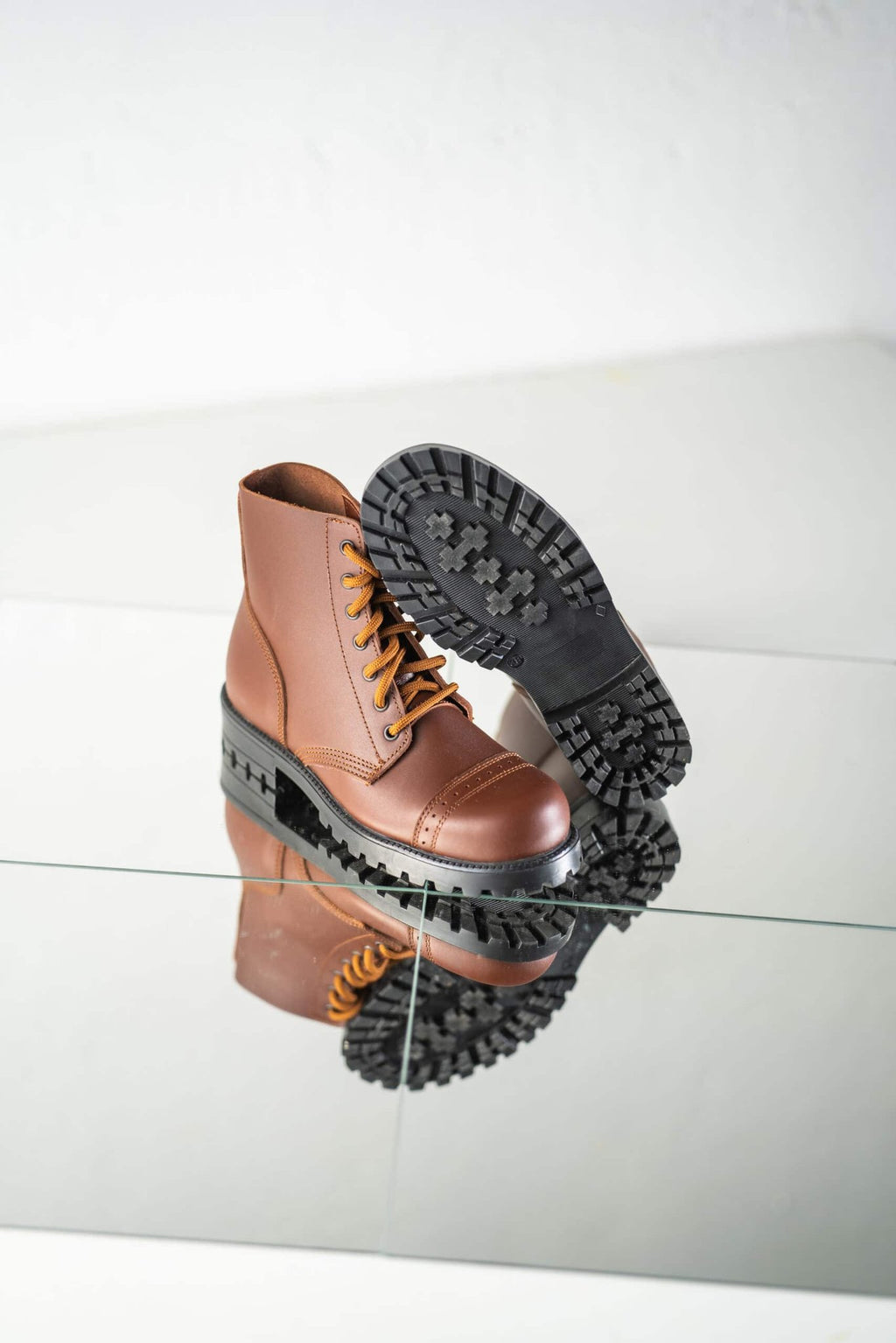 5. Unisex brown Samelin 517 Aviator Boots with one boot showing sole pattern for superior grip
