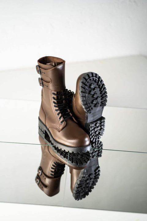 5. Unisex Tarkovsky Boots in dark brown leather, showing tread pattern on sole, displayed on reflective surface