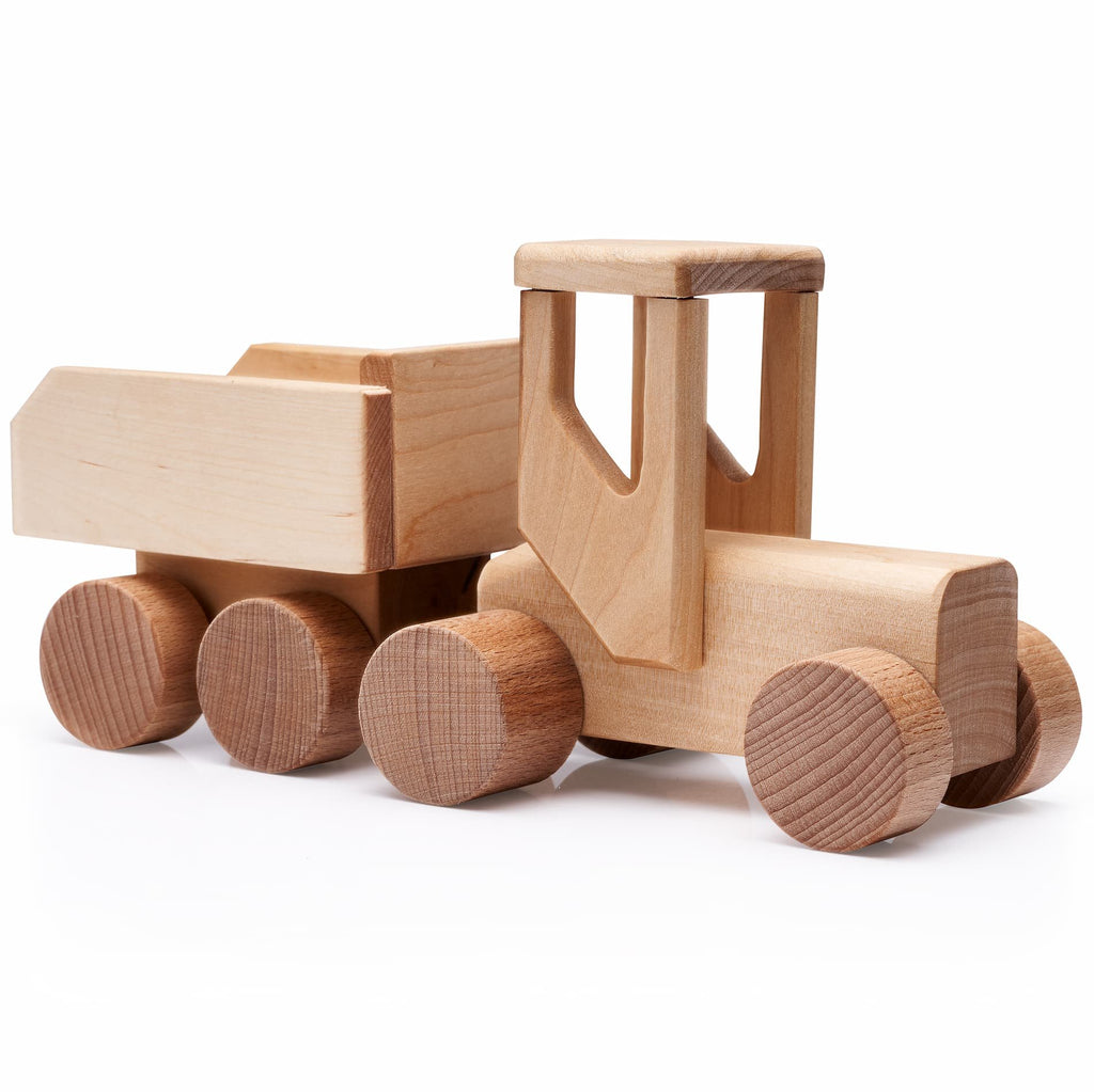 2. Studio shot of unpainted wooden toy tractor made from birchwood, highlighting natural material and craftsmanship