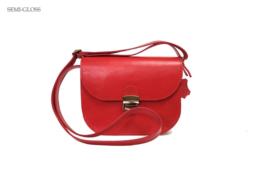 5. Studio shot of Zelma Kraft red leather saddle bag, highlighting semi-gloss finish and adjustable strap