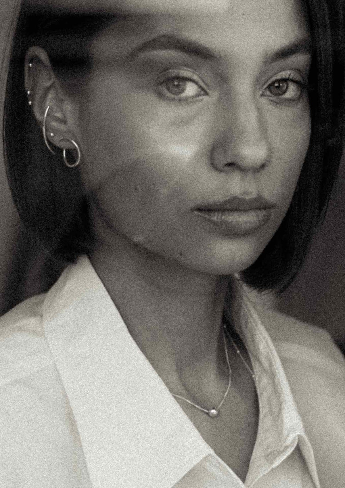 2. Close-up of woman wearing NO MORE Radius earrings in silver, highlighting minimalist style