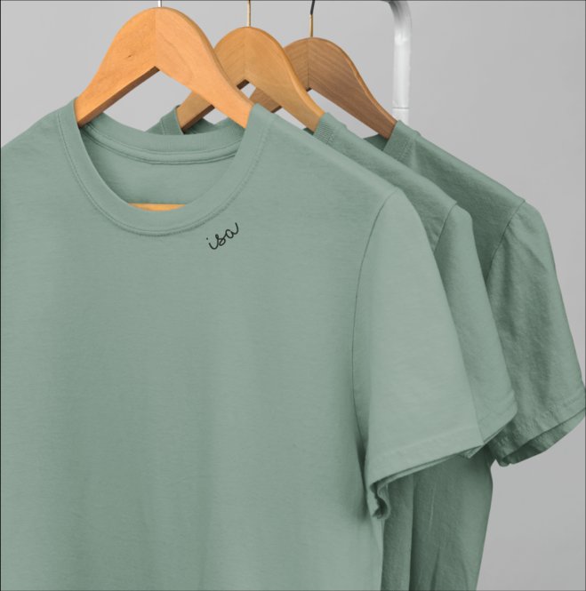 5. Studio shot of three green organic cotton T-shirts by Beebila on hangers, highlighting embroidered collar