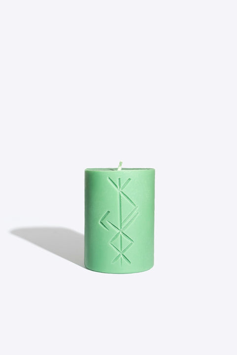 2. Studio image of Smells Like Spells Rune candle FREYR in green, highlighting rune design and soy wax