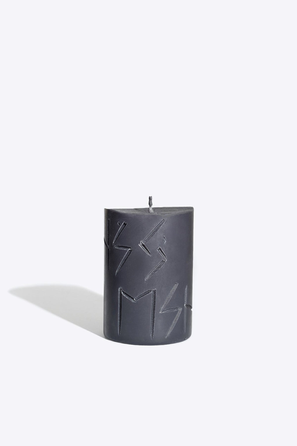 3. Studio image of Rune Candle HAG by Smells Like Spells, showcasing engraved runes, made from pure soy wax