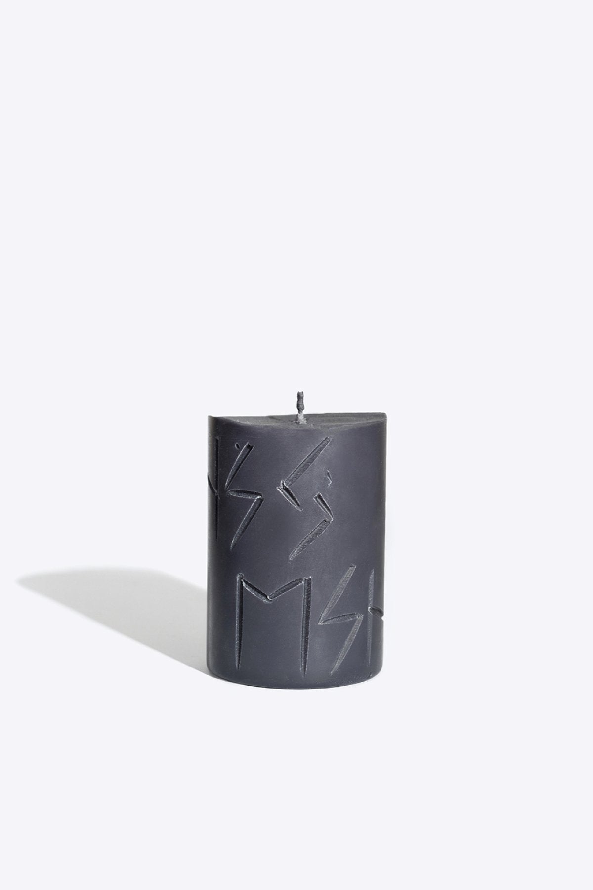 3. Studio image of Rune Candle HAG by Smells Like Spells, showcasing engraved runes, made from pure soy wax