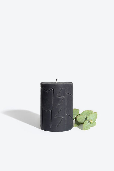 2. Smells Like Spells Rune Candle HEL in black with eucalyptus accent, studio setting