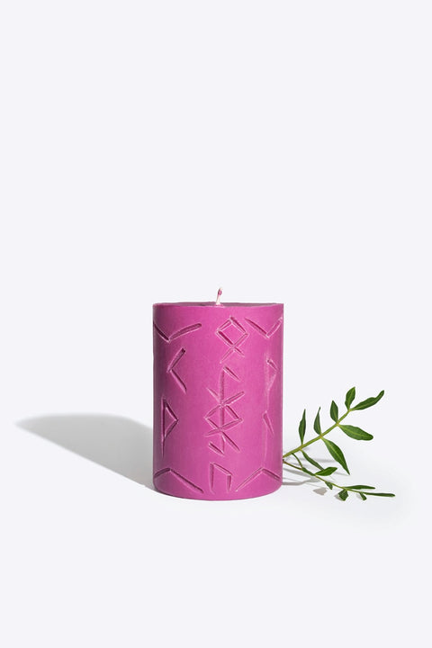 1. Rune Candle MIMIR by Smells Like Spells in purple with carved symbols, shown with greenery in studio setting