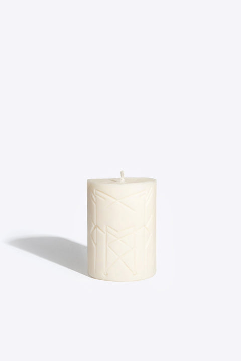 1. Smells Like Spells Rune Candle NORNS in studio setting, showcasing runic symbols on soy wax