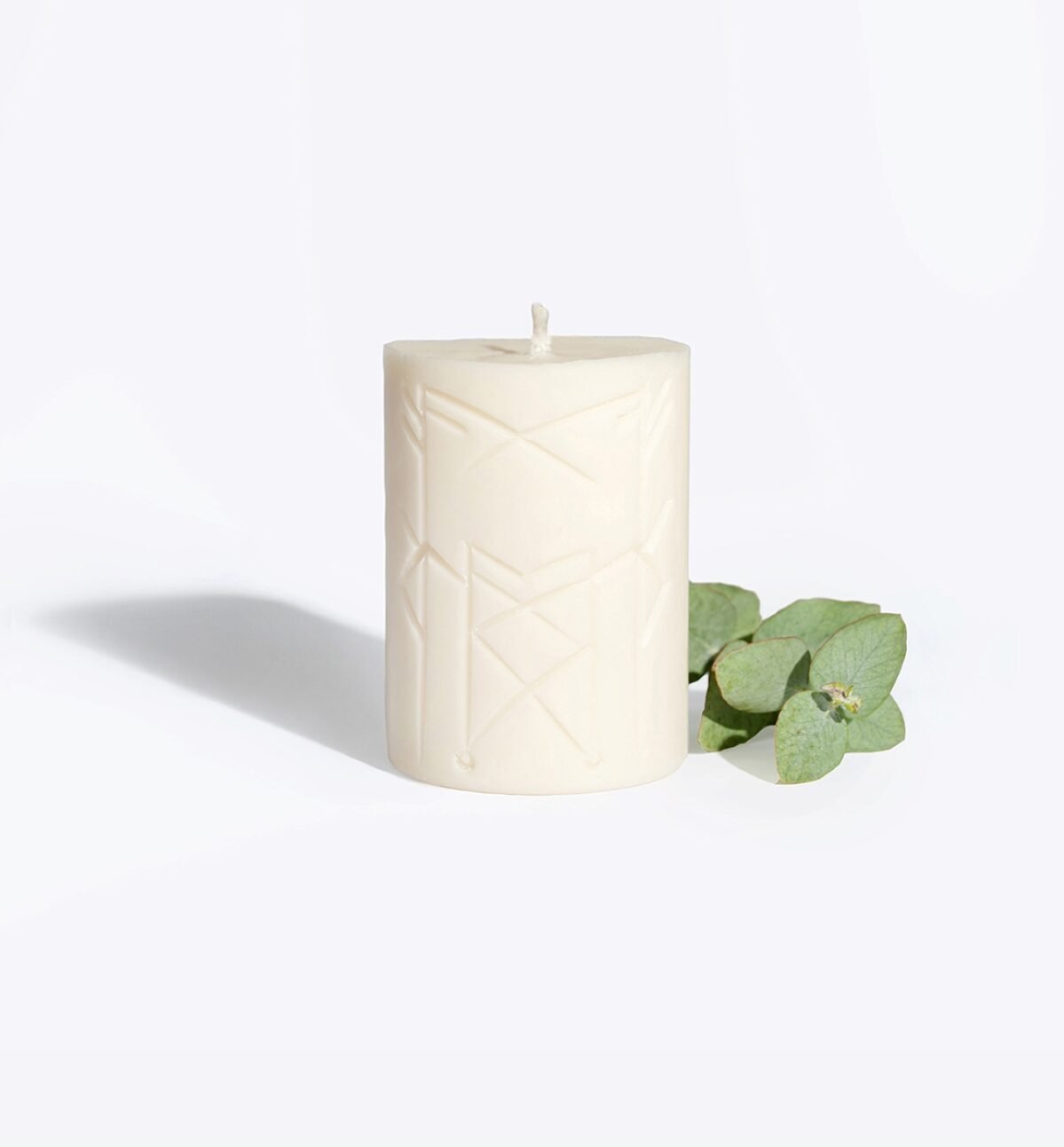 3. Smells Like Spells Rune Candle NORNS with eucalyptus, emphasizing eco-friendly soy wax and runic symbols