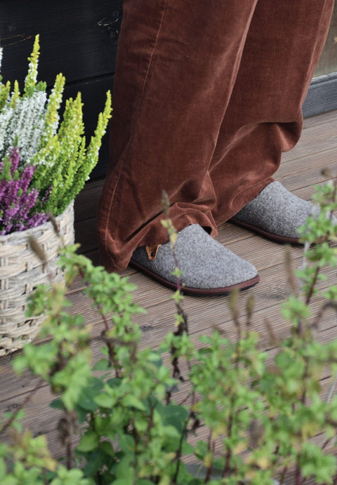 1. Unisex Nursi slippers by Omaking worn outdoors, showcasing cozy felted wool design