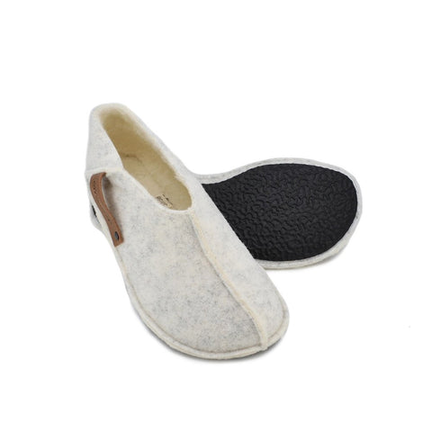 4. Studio image of Tohkri unisex slippers in white lambswool showing flexible rubber sole