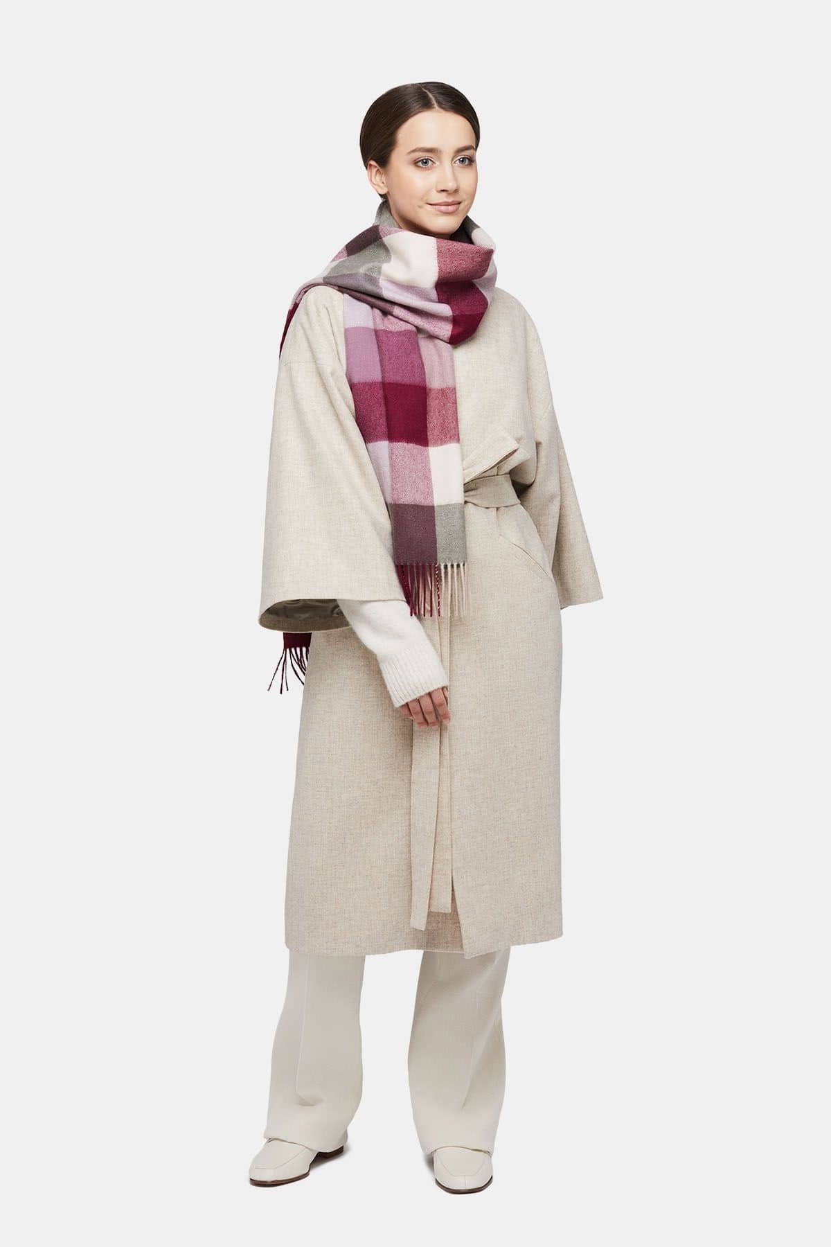 1. Women's natural baby alpaca wool check scarf in pink and white, worn by model in lifestyle setting