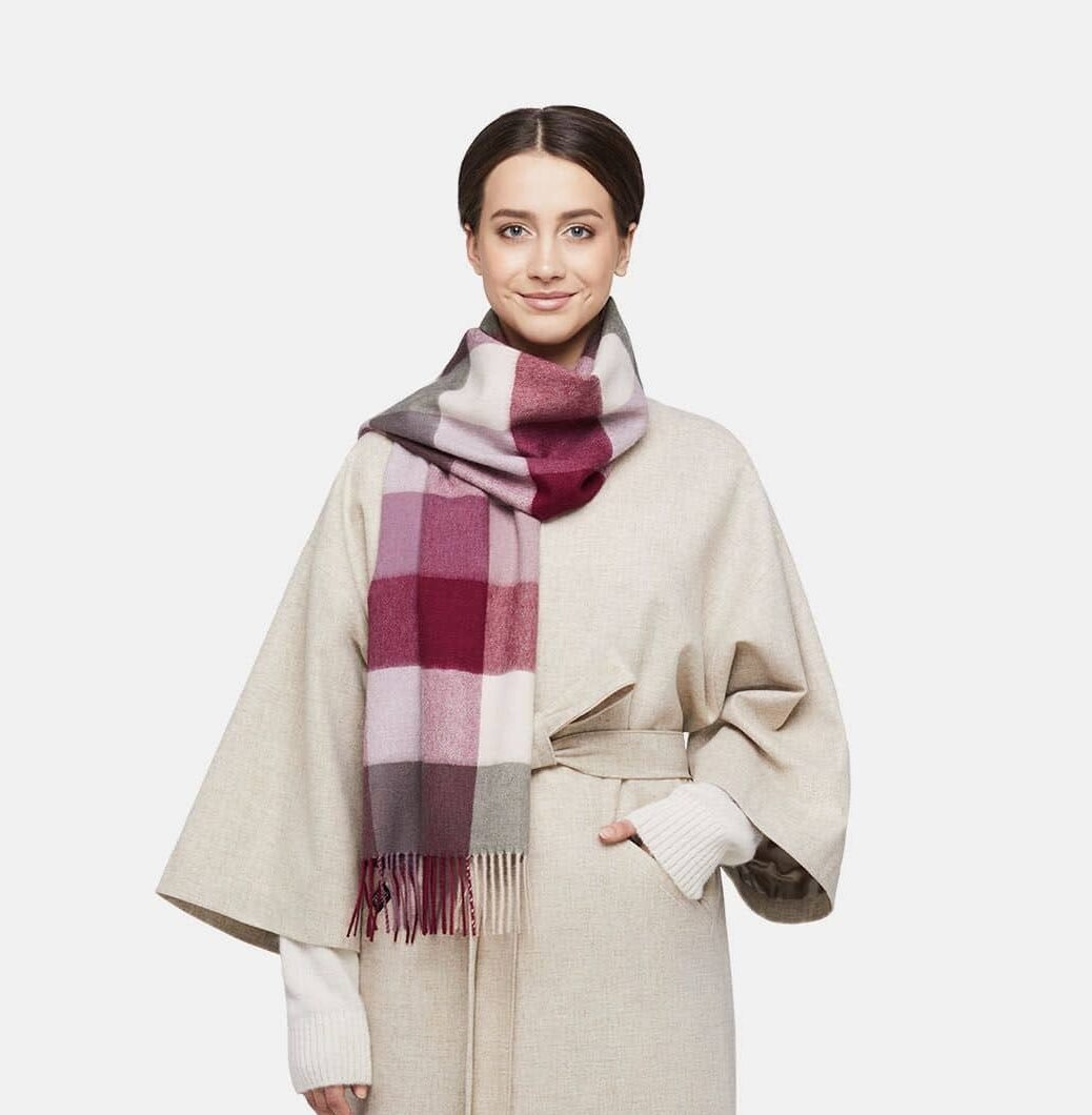 1. Women's natural baby alpaca wool check scarf in pink and white, worn by model in lifestyle setting