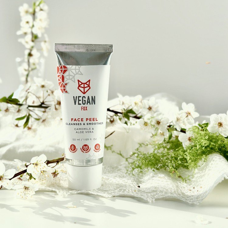 2. Vegan Fox Face Peel tube with chamomile and aloe vera, surrounded by white flowers in a lifestyle setting