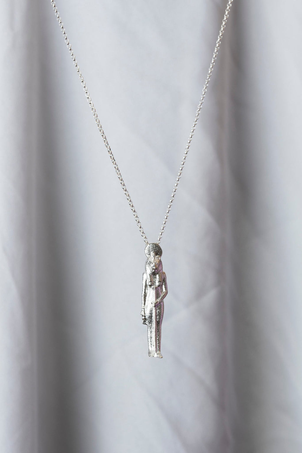 1. Sekhmet Fire Necklace in silver by New Vintage by Kriss, shown hanging against a soft background