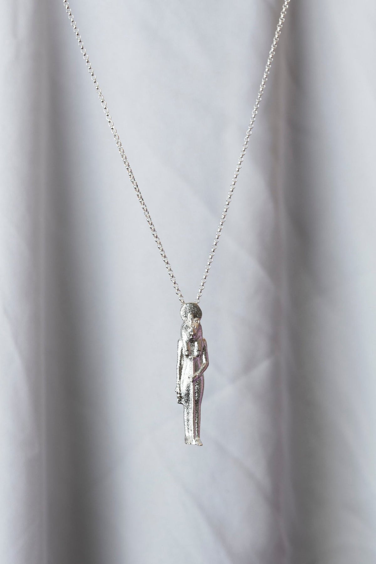 1. Sekhmet Fire Necklace in silver by New Vintage by Kriss, shown hanging against a soft background