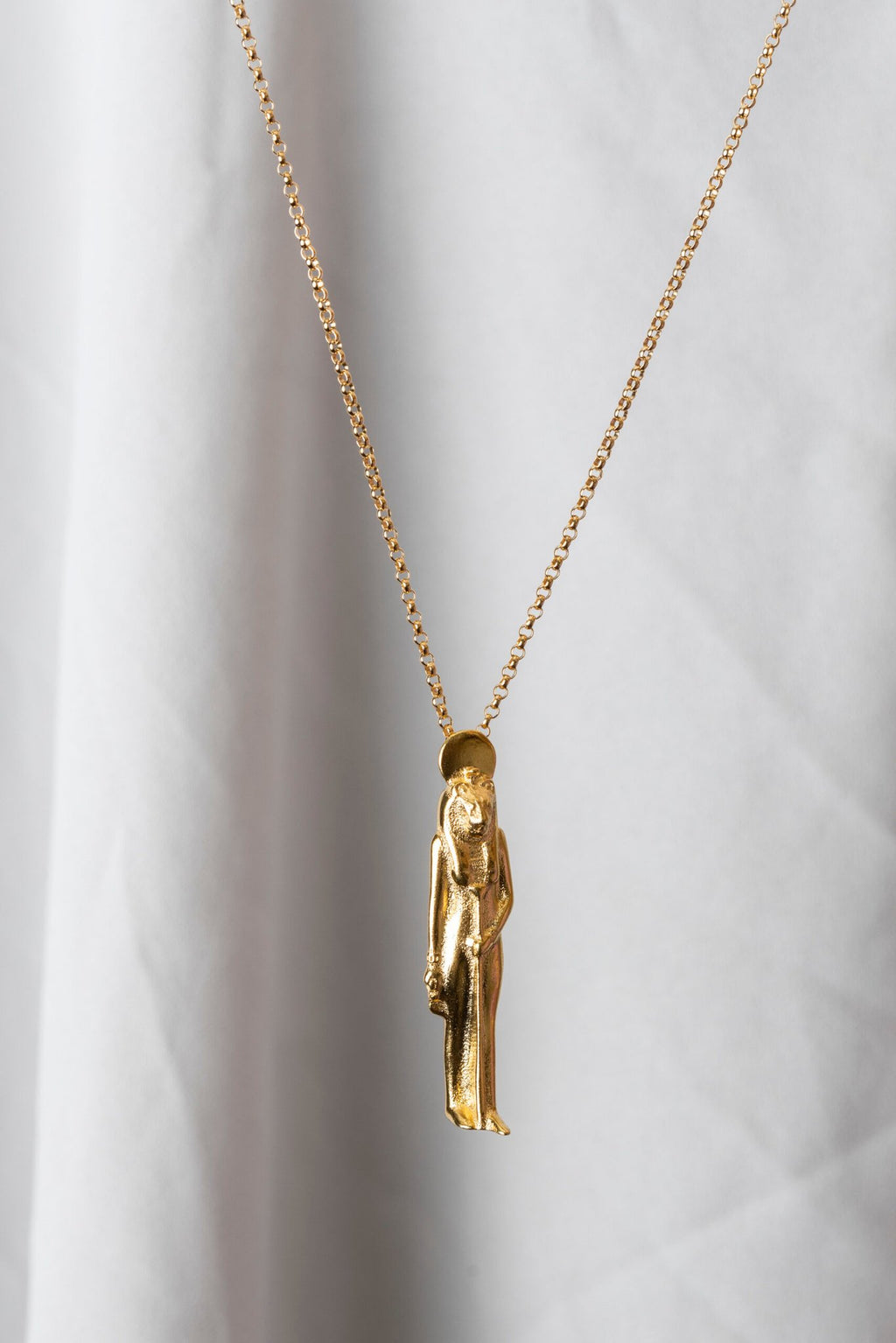 2. Sekhmet Fire Necklace in gold by New Vintage by Kriss, displayed against a light fabric backdrop