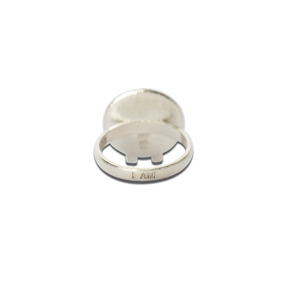 4. Close-up of Sekhmet Fire Necklace Ring in silver, highlighting 'I AM' engraving on the band