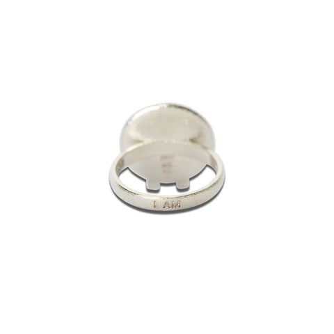 4. Close-up of Sekhmet Fire Necklace Ring in silver, highlighting 'I AM' engraving on the band